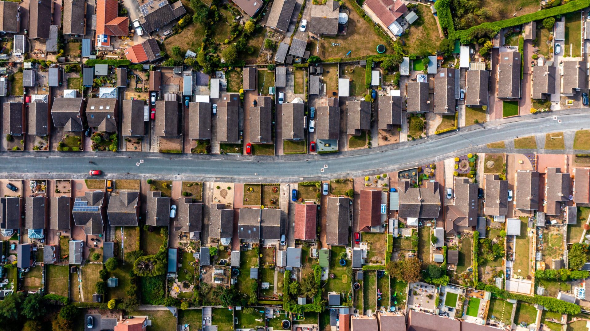 Aerial view directly above a suburban housing estate with a road providing access for homeowners